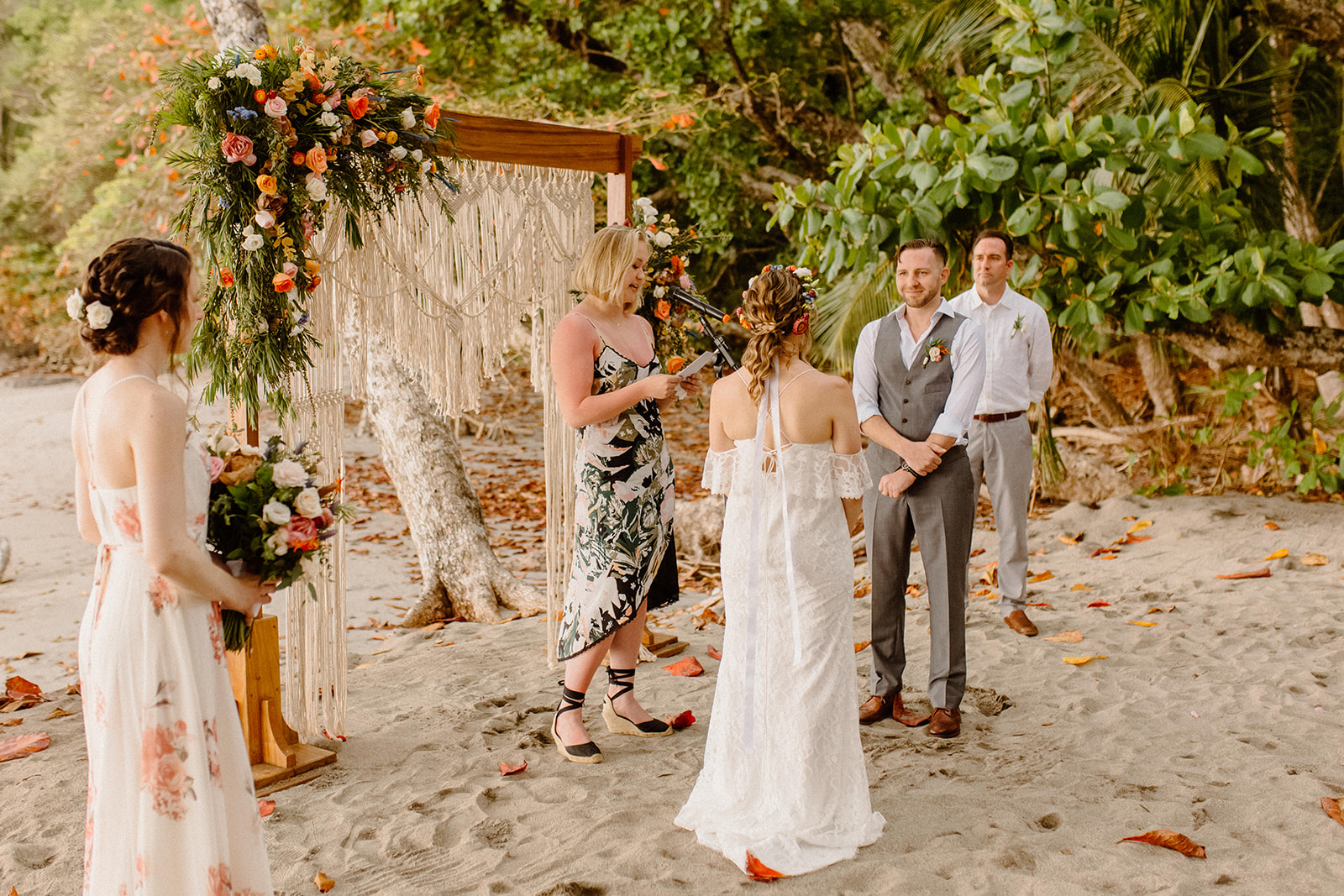 Bride and groom standing during wedding ceremony on the beach