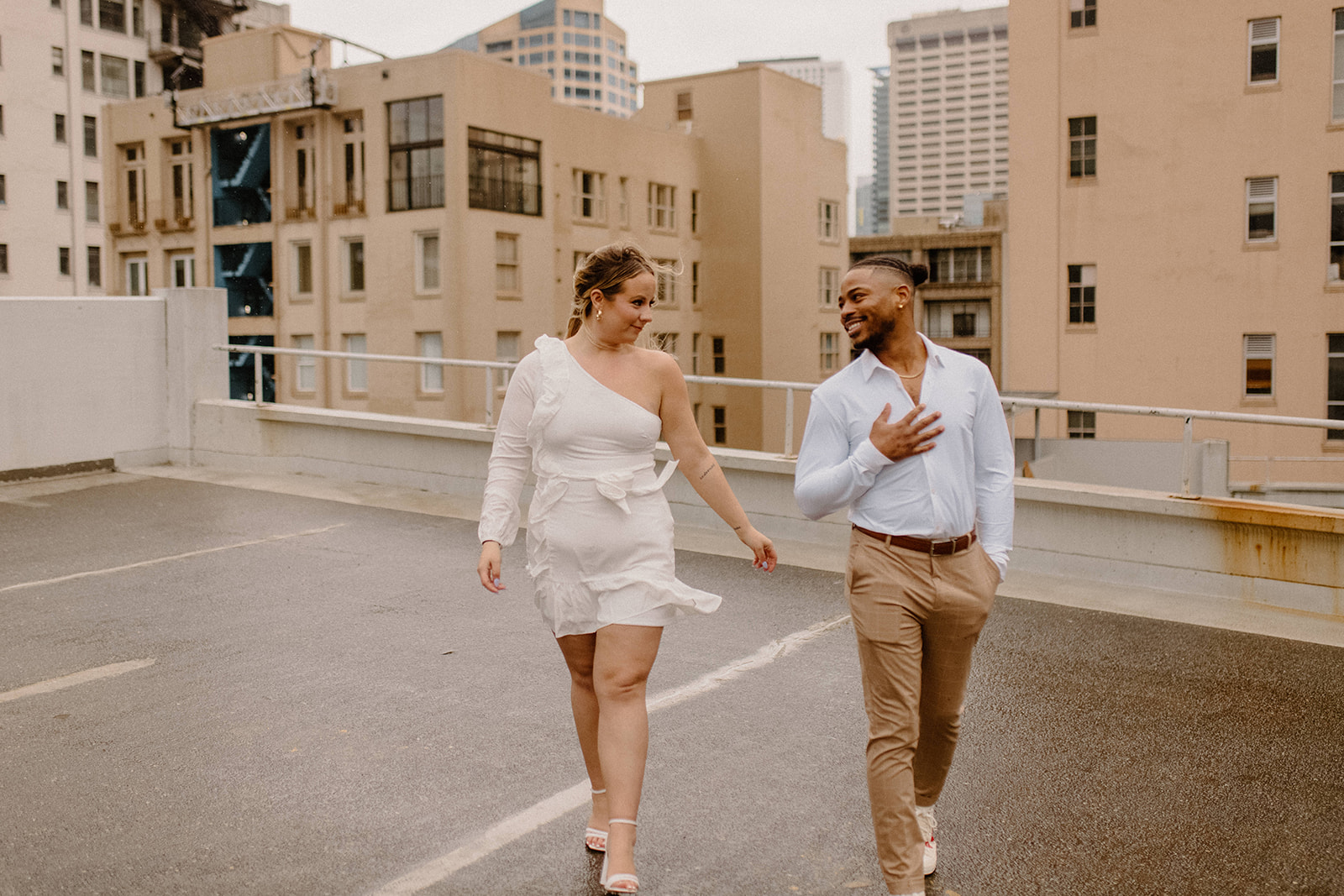Couples photos in the rain for a rooftop engagement session
