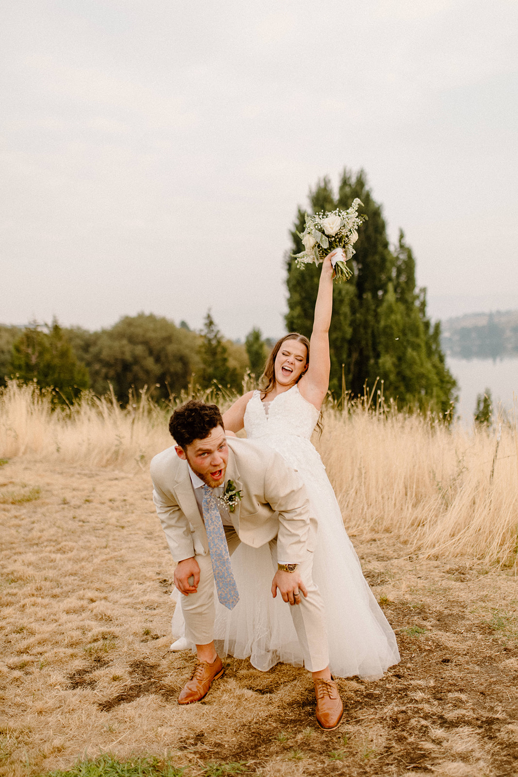 Beautiful Bride and Groom dancing in grass fields
