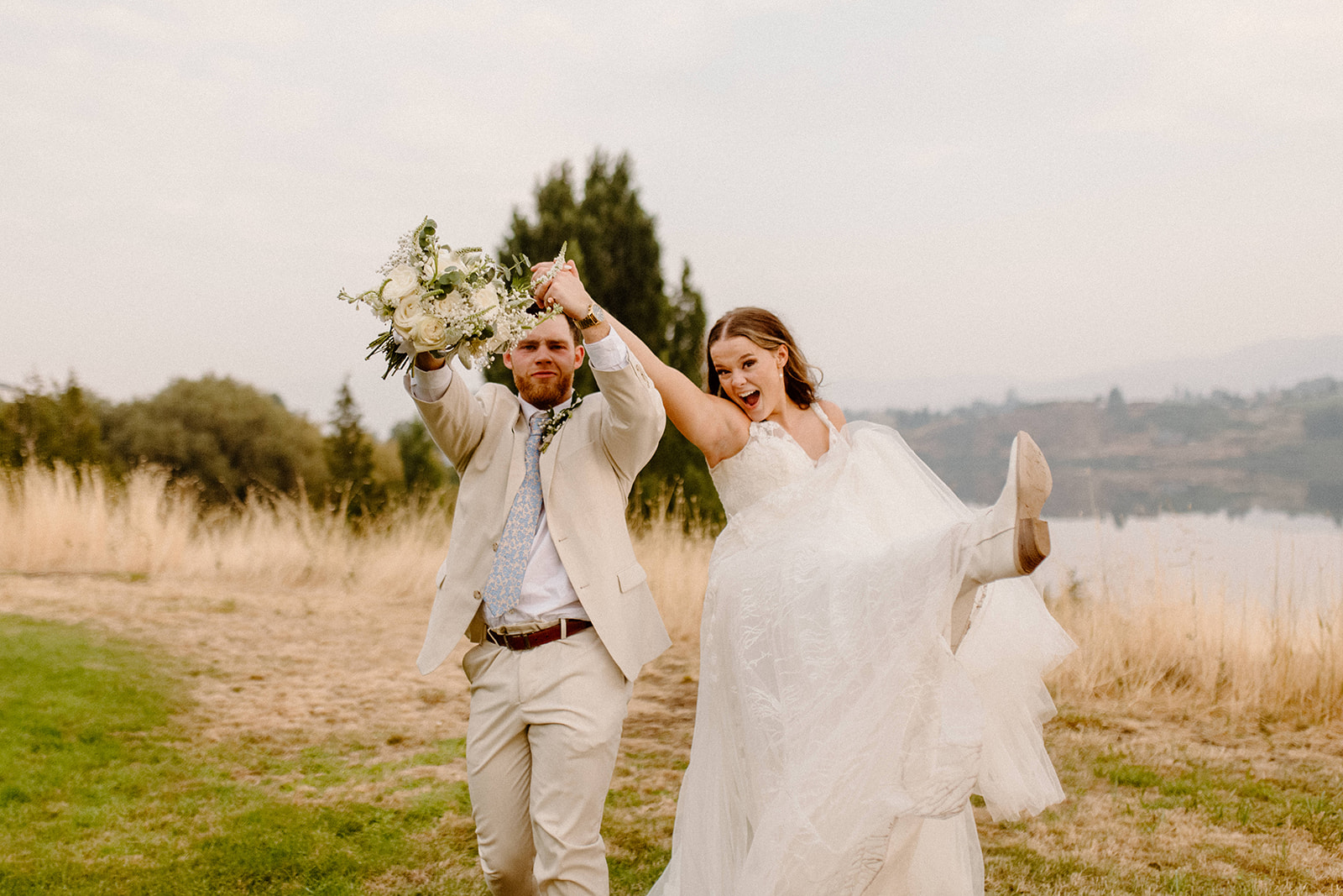 Beautiful Bride and Groom dancing in grass fields