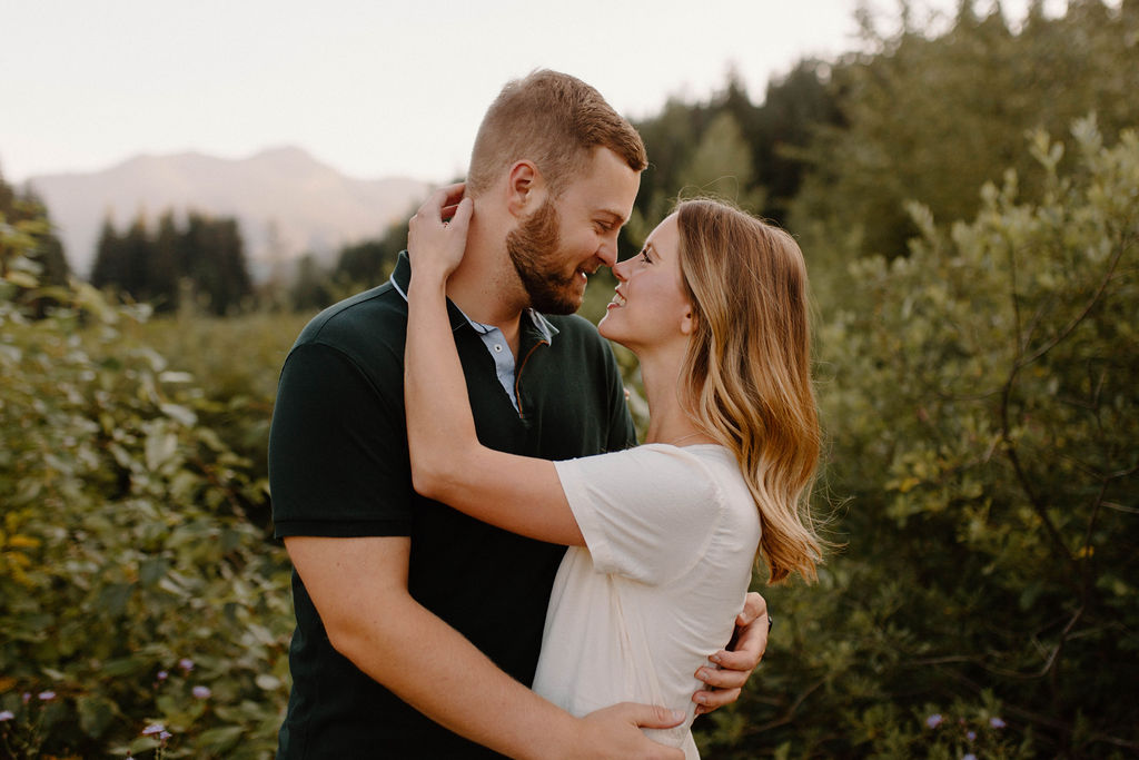 Gold Creek Pond Engagement Photos with Pond and mountain backdrops