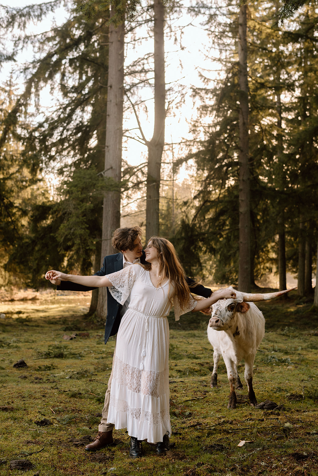 Couple holding hands during their PNW Engagement Photos with cows in a field