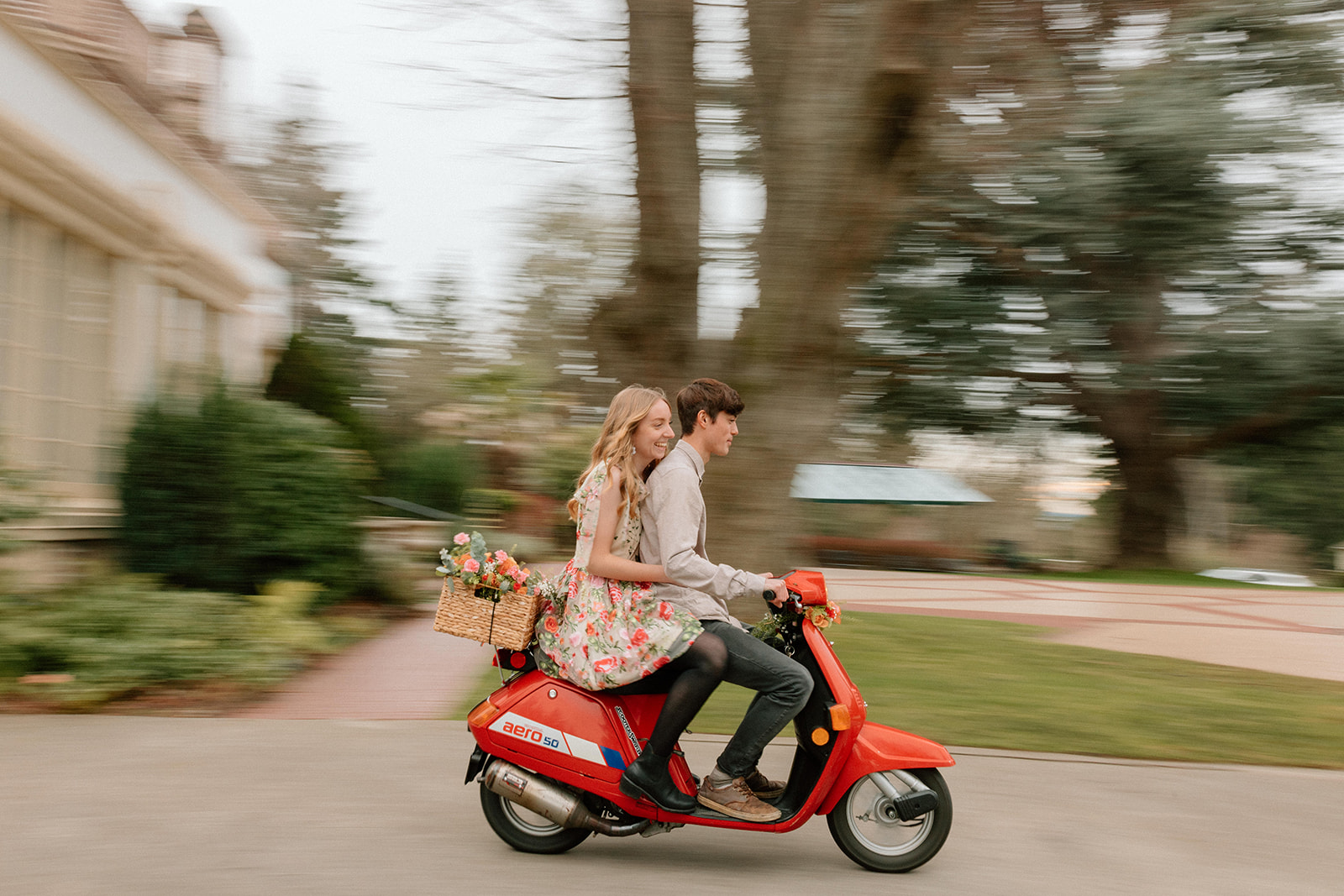 Couple riding a scooter at Lairmont Manor for their couples photography session
