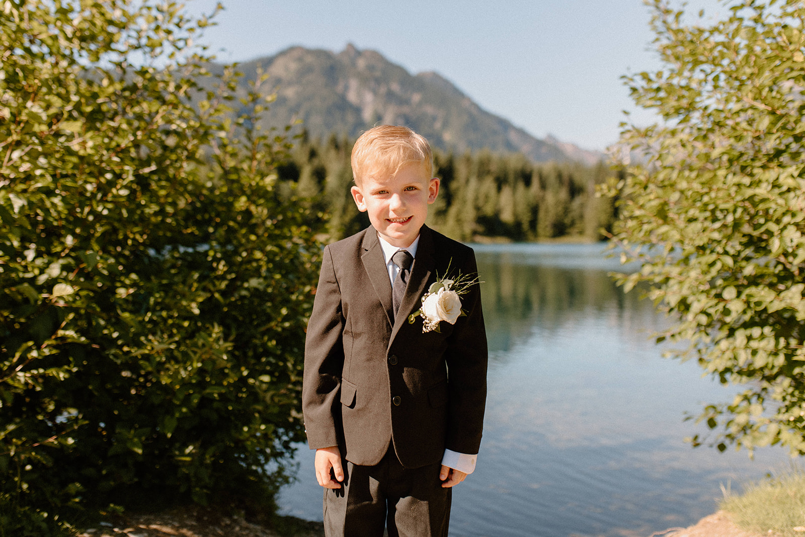 Brides son smiling in a black and white suite