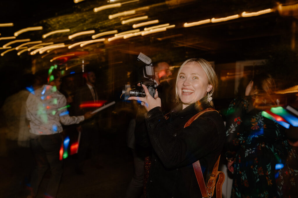 Photographer photographing the dancing at a wedding with colorful lights
questions to ask wedding vendors