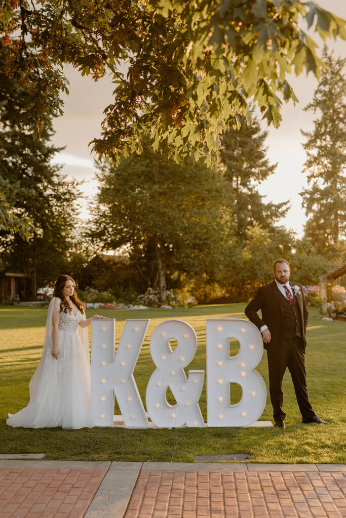 Bride and Groom standing next to Marque initials on their wedding day
questions to ask wedding vendors 