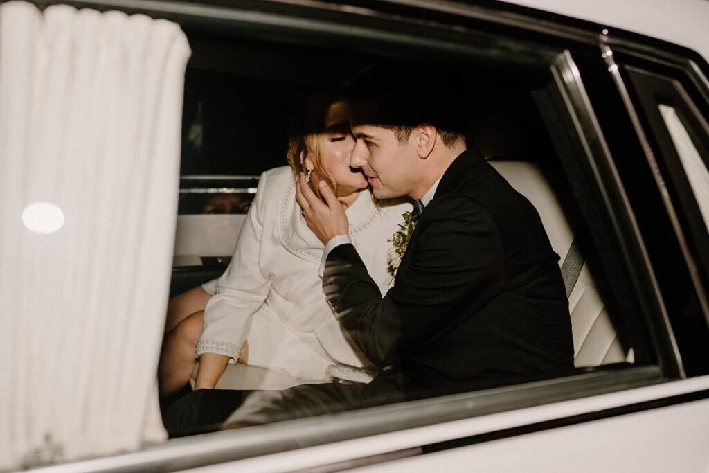 Bride kissing grooms cheek at the end of the night in their wedding getaway car
questions to ask wedding vendors