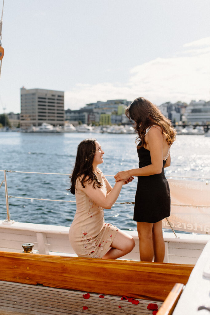 Two females getting engaged on a sailboat in Lake Union Seattle now needing wedding planning tips