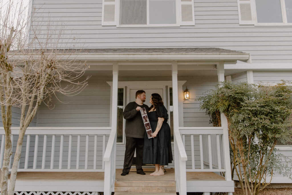Couple on their porch to announce their pregnancy.