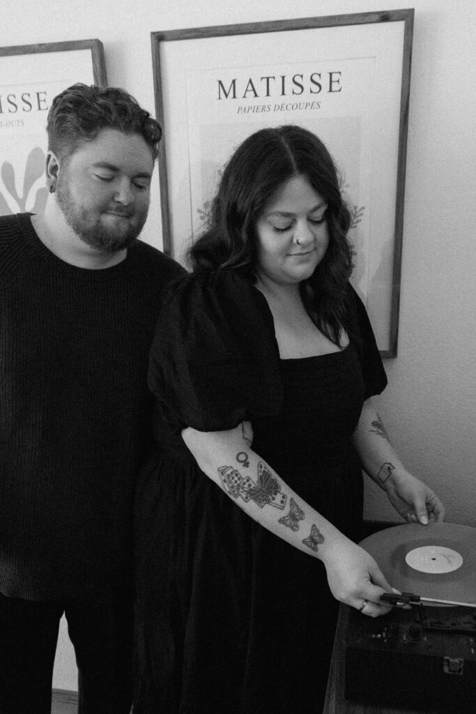 A couple putting on a record during their photoshoot.
