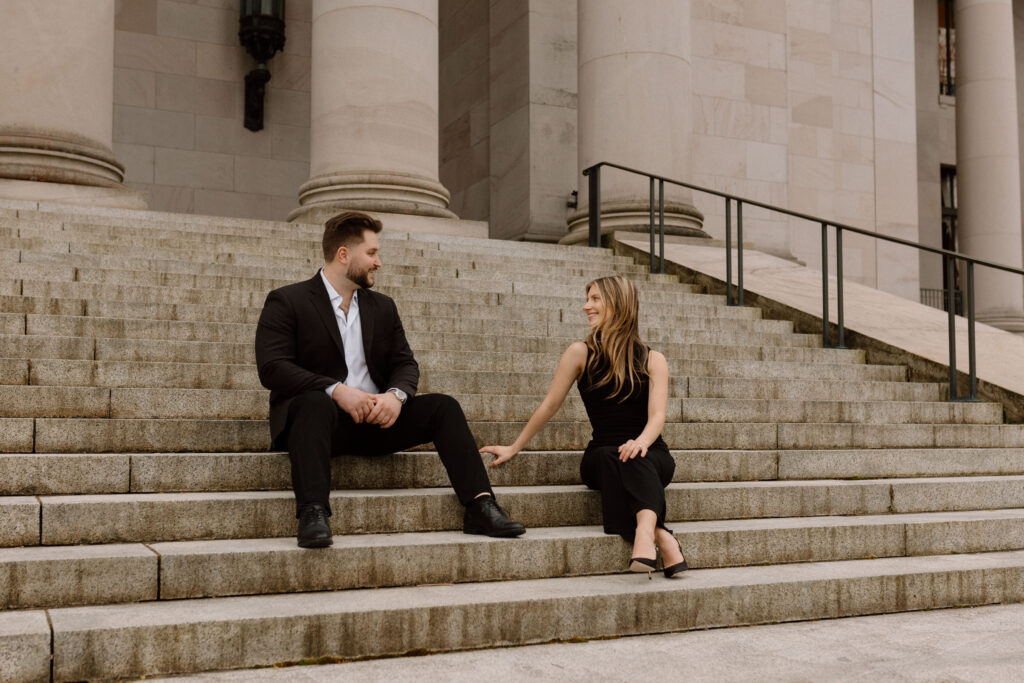 Couple sitting on the Washington State Capitol building steps for their classic engagement photos.