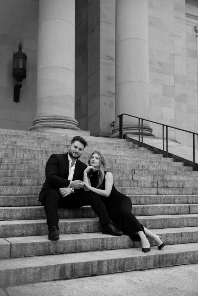 Couple sitting on the Washington State Capitol building steps for their classic engagement photos.