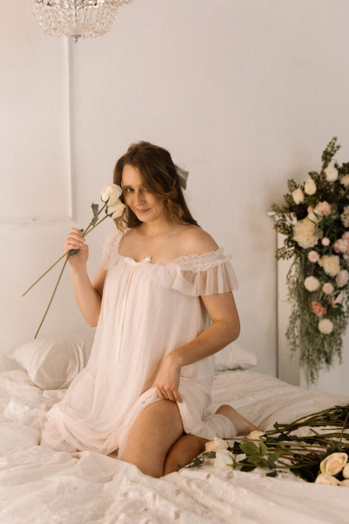 Seattle Boudoir photograph of a woman holding a rose in a nightgown.