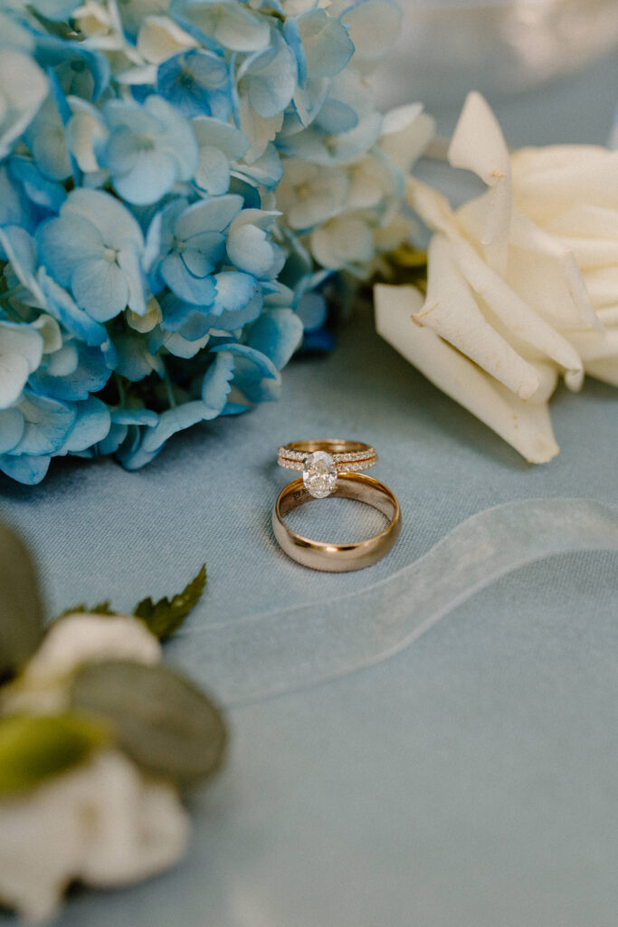 wedding rings on a blue wedding centerpiece 