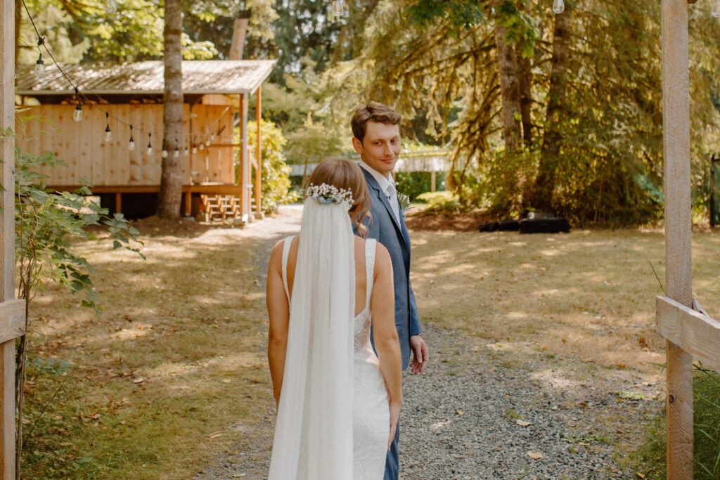 bride and groom first look at river valley oasis wedding venue in granite falls Washington