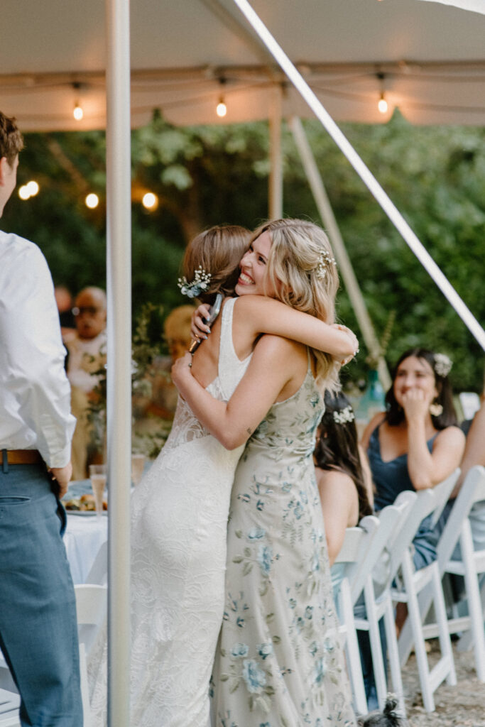 bride hugging her sister and maid of honor