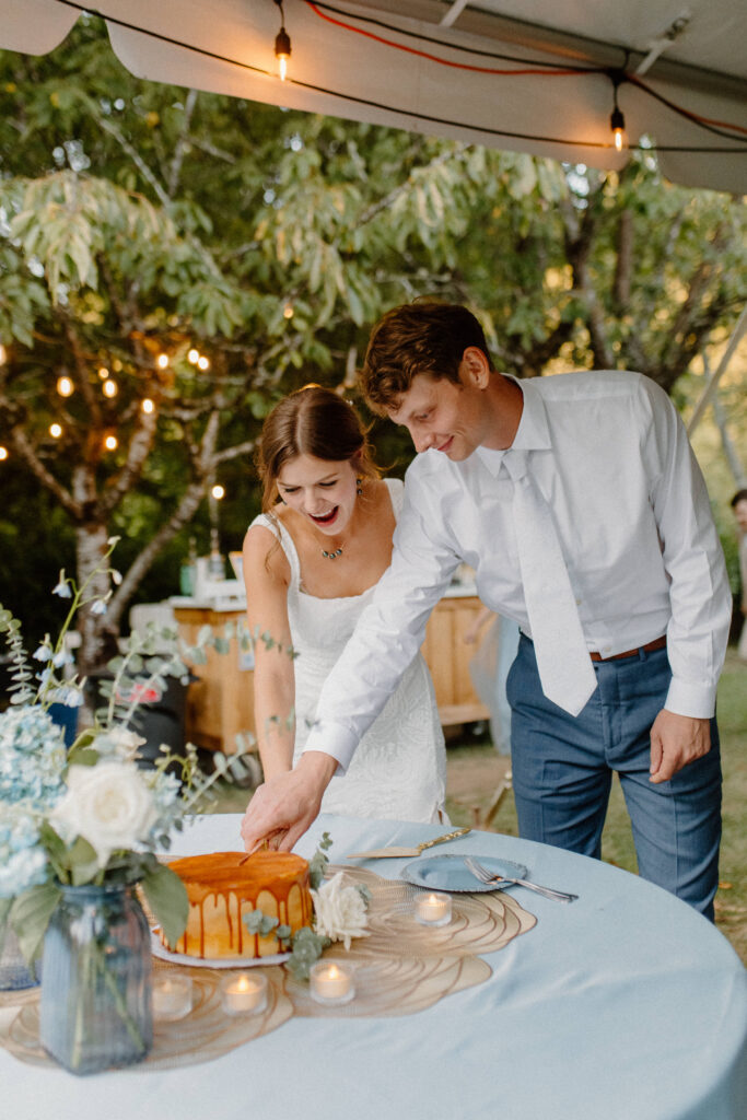 bride and groom cut the wedding cake 