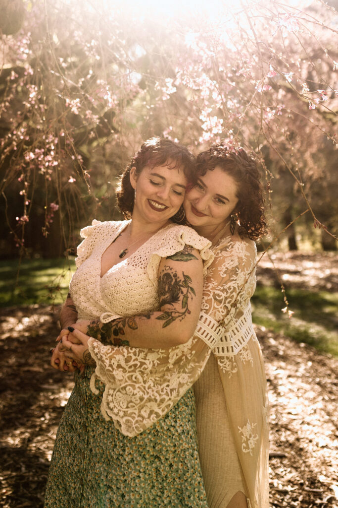lesbian engagement photos hugging and smiling