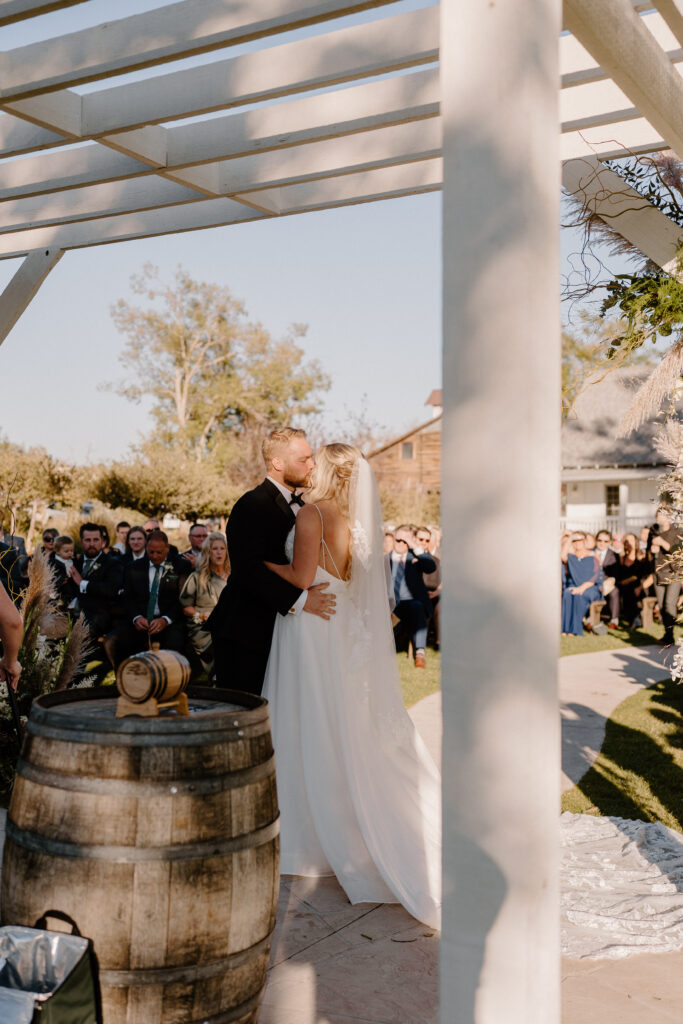 bride and groom first kiss