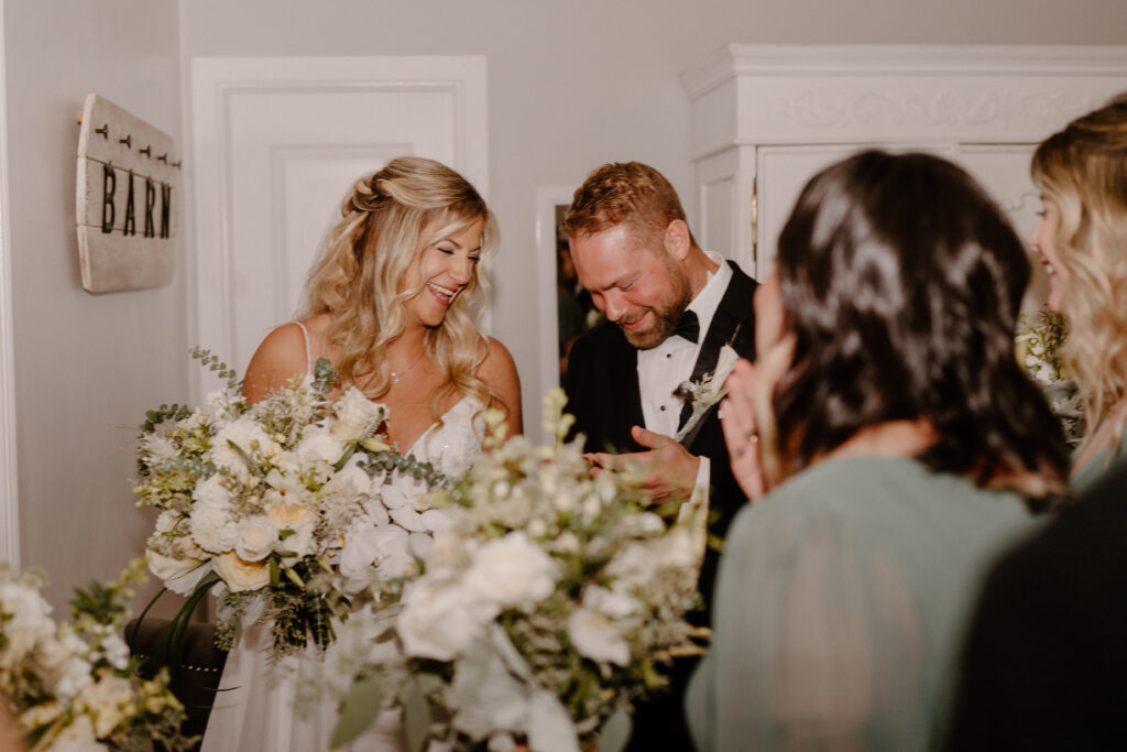 bride and groom after ceremony looking at their rings