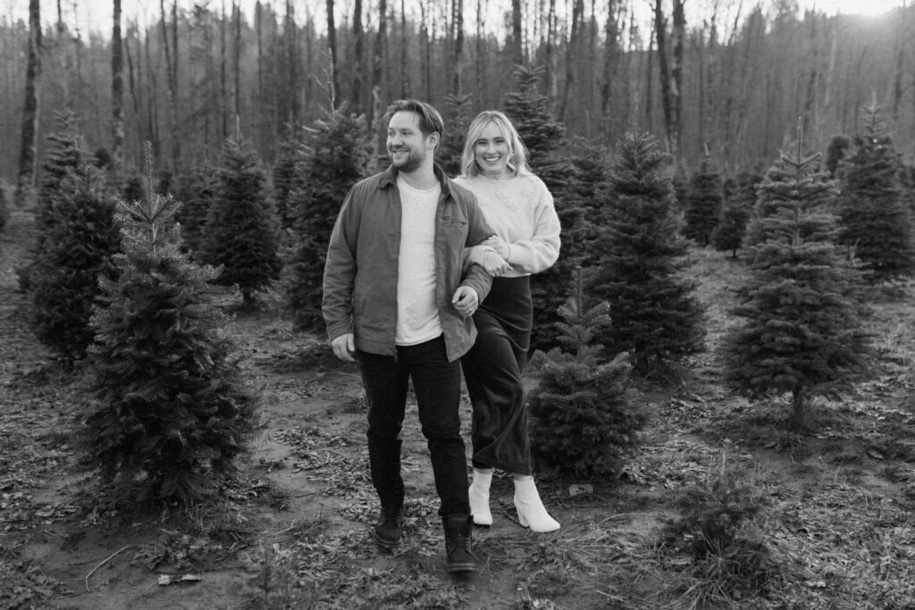 couples posing for holiday tree farm photoshoot