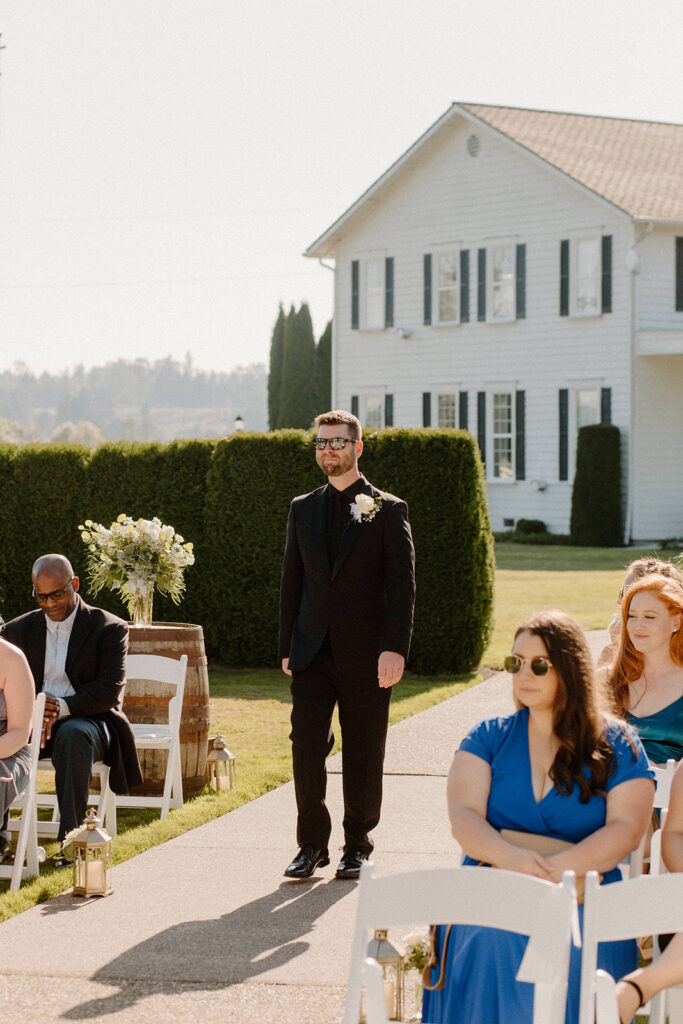 groom walking down aisle portrait