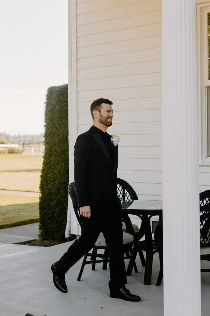 groom walking to first look