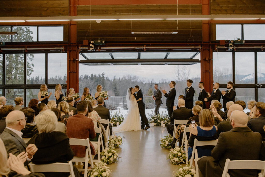 first kiss at winter wedding ceremony at olsen mansion