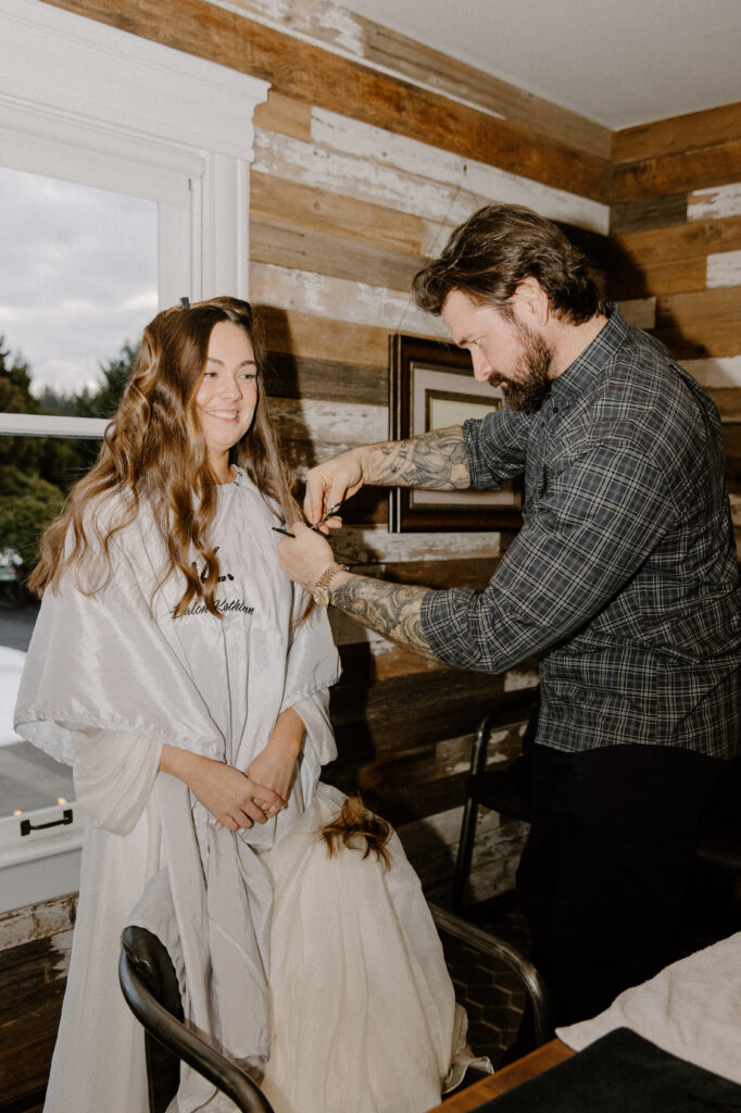 bride getting her hair cut on her wedding day
