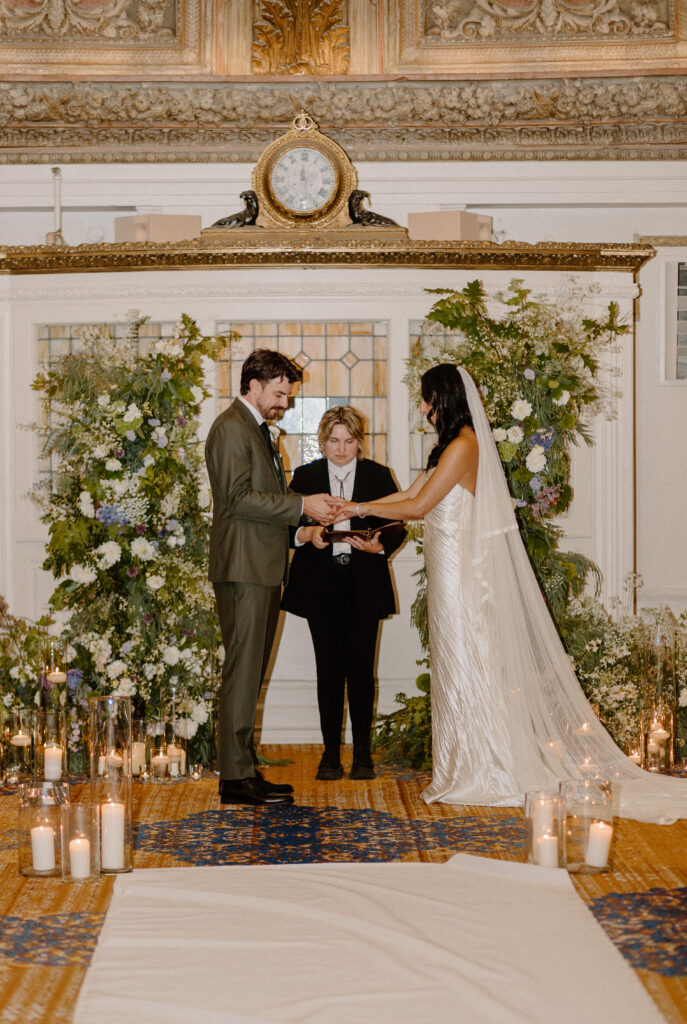 Bride and groom exchange rings at wedding ceremony