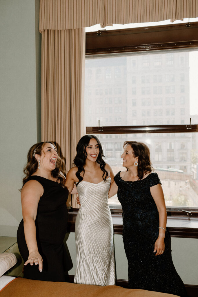 Bride getting ready with her mom and sister
