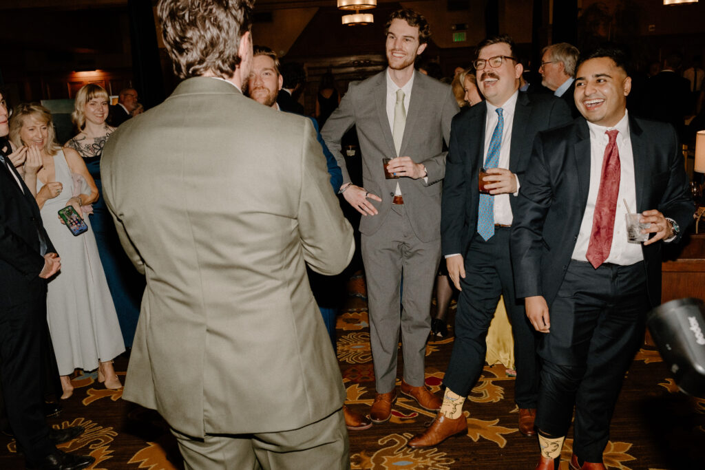 groom with friends at wedding reception