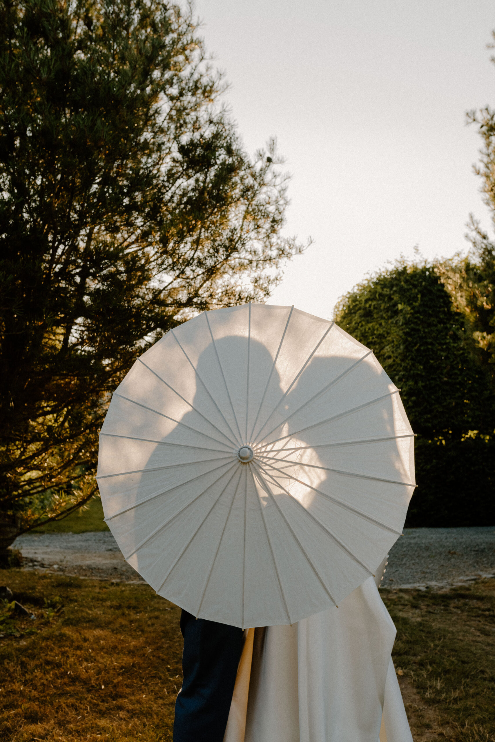 bride and groom wedding portrait with shadow through a parasol